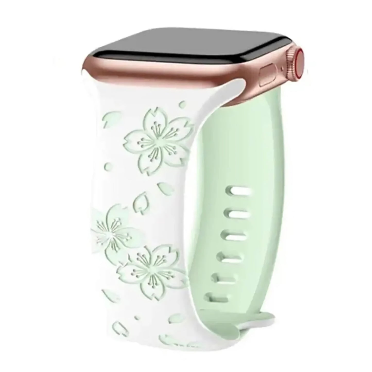 Das arktisband Apple Watch Armband „Flores“ besteht aus einem hellgrünen Silikonband mit geprägten weißen Blumen, Blattmotiven und einem eleganten Blumenmuster. Mehrere Einstelllöcher sorgen für perfekten Sitz. Kompatibel mit Ihrem Roségoldgehäuse.