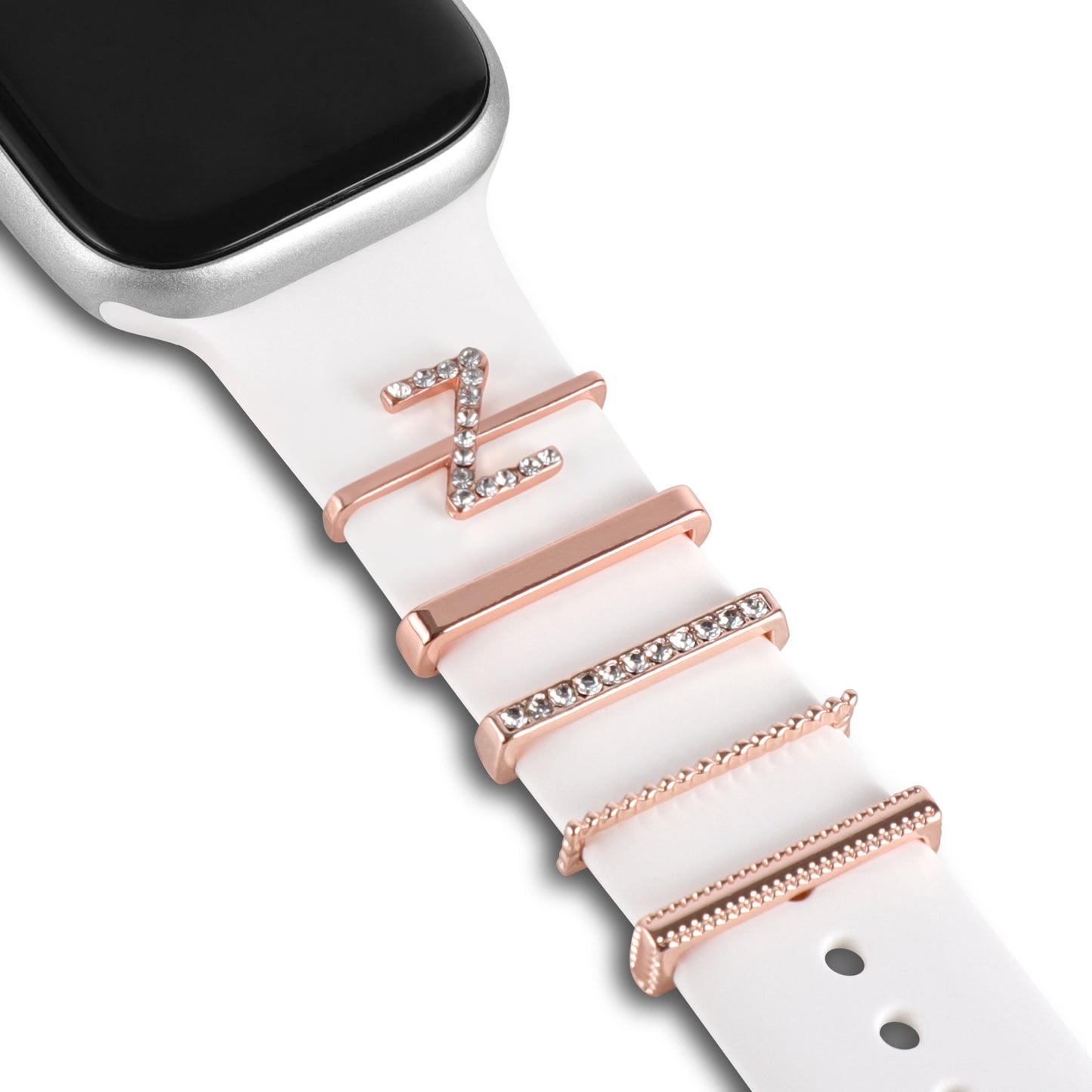 Nahaufnahme der Arktisband Apple Watch Charms „Z Style“ – weißes Band mit Charms aus Roségold und Kristall, einschließlich des Buchstabens Z.