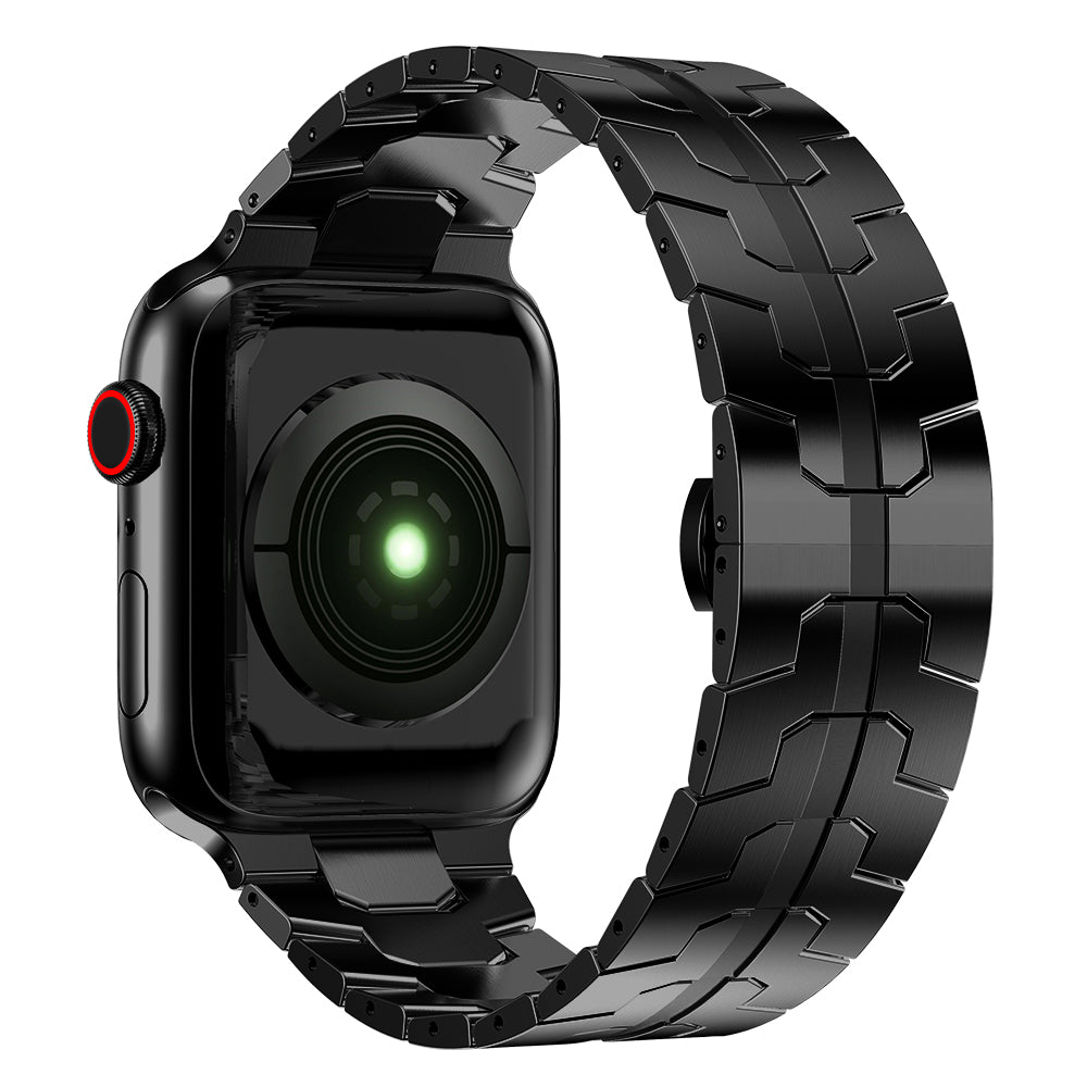 Eine Nahaufnahme des arktisband Apple Watch Edelstahl Armbands „Momento“ zeigt die schwarze Smartwatch mit einem Edelstahlgliederband und einem grün beleuchteten Sensor auf der Rückseite, fotografiert vor einem weißen Hintergrund.