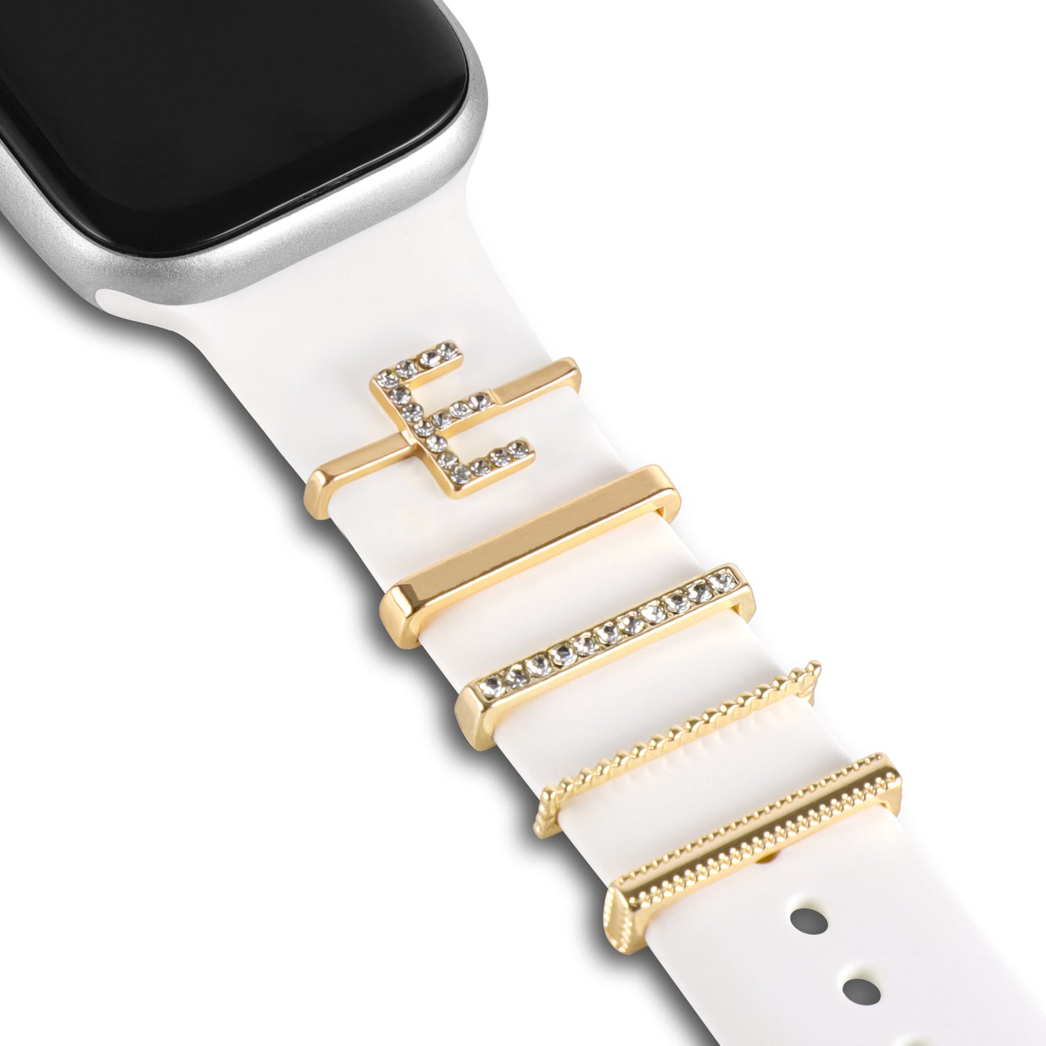 Nahaufnahme der arktisband Apple Watch Charms „E Style“: Gold- und Kristall-Akzente von arktisband verleihen einem weißen Band Eleganz.