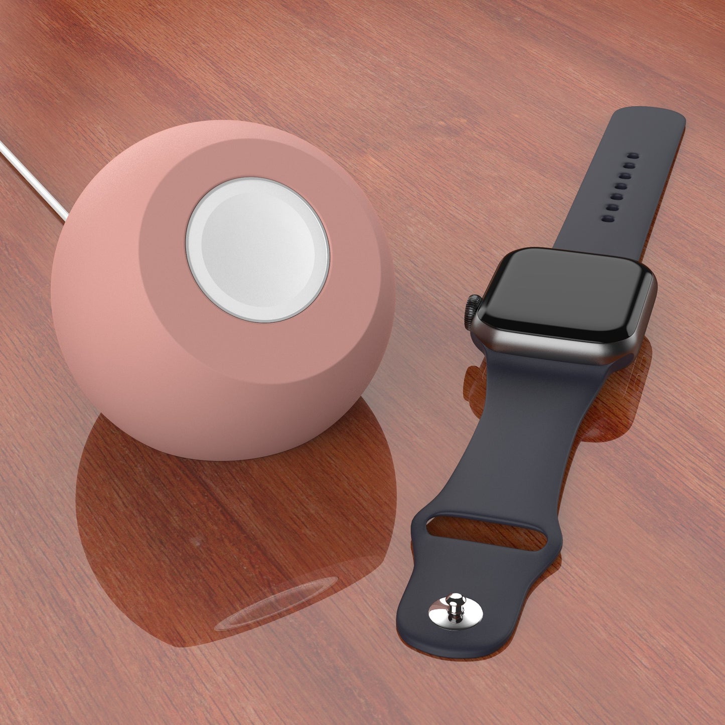 Ein arktis Apple Watch Orbit Stand steht auf einer Holzfläche neben einer Smartwatch mit dunklem Band und einem runden, rosafarbenen Silikon Ladegerät Halter.