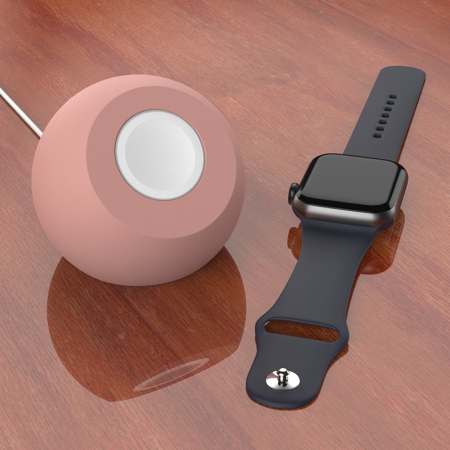 Ein arktis Apple Watch Orbit Stand steht auf einer Holzfläche neben einer Smartwatch mit dunklem Band und einem runden, rosafarbenen Silikon Ladegerät Halter.