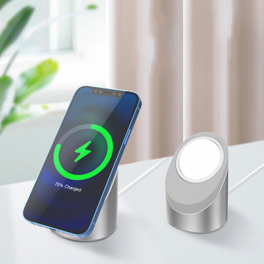 Ein arktis Smartphone wird kabellos auf einem silbernen arktis MagSafe NightStand neben einer leeren, passenden iPhone Ladestation aufgeladen, die beide auf einer weißen Fläche liegen.