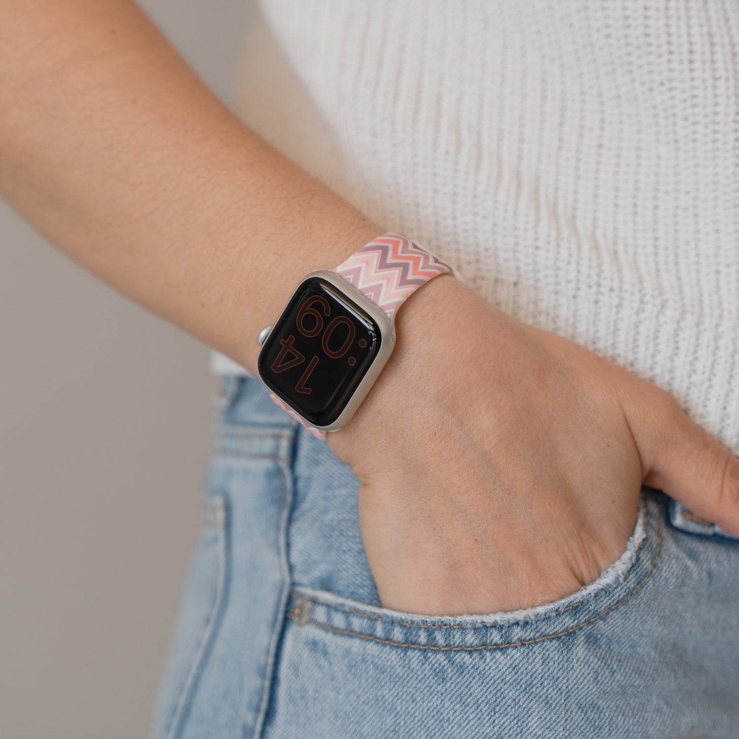 Eine Person trägt ein arktisband Vintage Boho Apple Watch Armband von arktisband, die Hand in der Jeanstasche und das weiße Strickoberteil sichtbar - ideal für sportliche Aktivitäten und den täglichen Style.