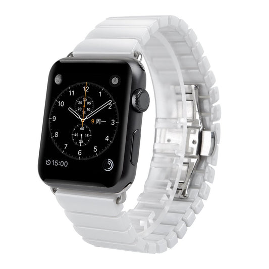 Eine schwarze Apple Watch mit weißem Arktisband Gliederarmband Keramik zeigt auf ihrem Bildschirm ein analoges Zifferblatt an.